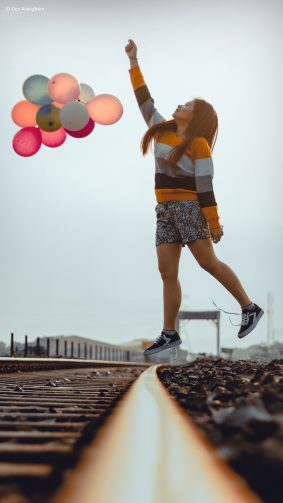 Happy Girl Jumping Balloons Train Track Photography 4K Ultra HD Mobile Wallpaper