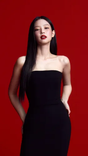 K-Pop Singer Jennie In Black Dress Red Background 4K Ultra HD Mobile Wallpaper